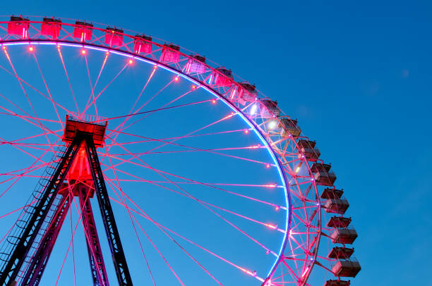 istock Big ferris wheel with festive colorful illumination 1011756650