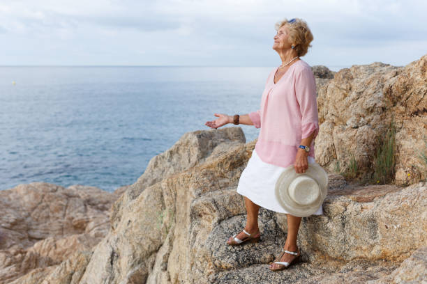 istock Senior woman relaxing at seaside 1011763640