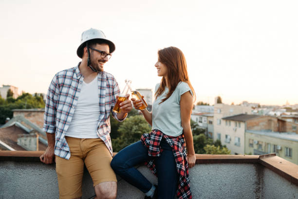 istock Happy couple enjoying drinks and balcony 1011767356