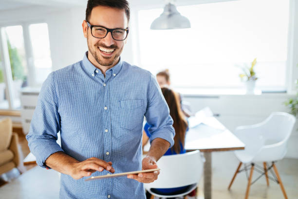 istock Portrait of handsome male manager using digital tablet 1011767966
