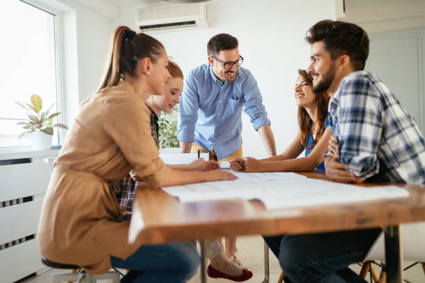 istock Group of young business people and architects working on project 1011768016