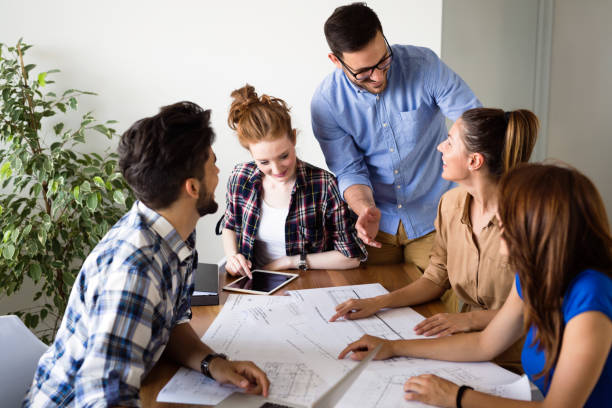 istock Image of business partners discussing documents and ideas 1011771500