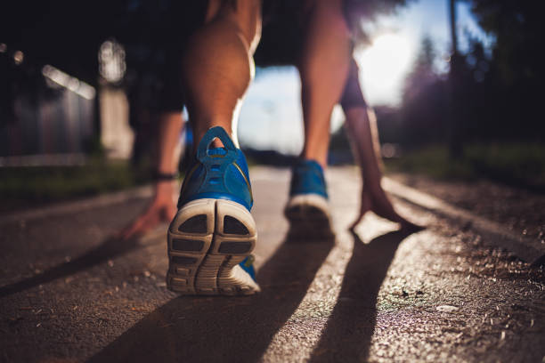 istock Young sports man in start position preparing to run 1011776058