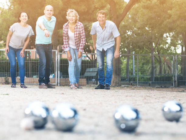 istock Smiling mature people playing petanque 1011776322