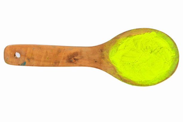 istock light yellow powder on wooden spoon with clipping path 1011776650