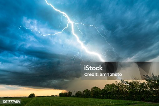 istock cloud storm sky with thunderbolt over rural landscape 1011777484