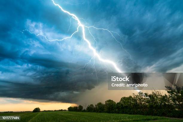 Cloud Storm Sky With Thunderbolt Over Rural Landscape Stock Photo - Download Image Now
