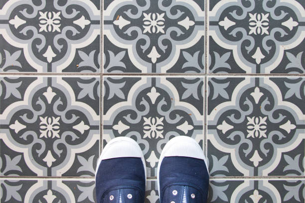 istock Close Up Spanish Tile Floor with Blue Shoes 1011782016