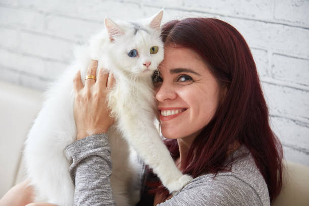 istock Cheerful woman with adorable cat 1011789084