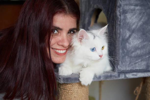 istock Woman petting cat 1011789168