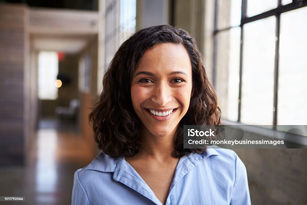 Young mixed race businesswoman smiling to camera Women Stock Photo