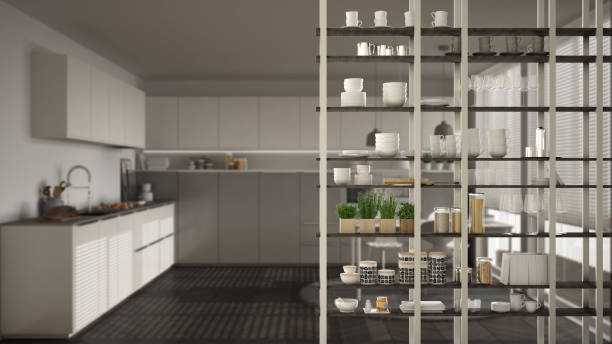 istock Kitchen living room shelving system foreground close-up, interior design concept, white and gray modern room open plan in the background 1011792122