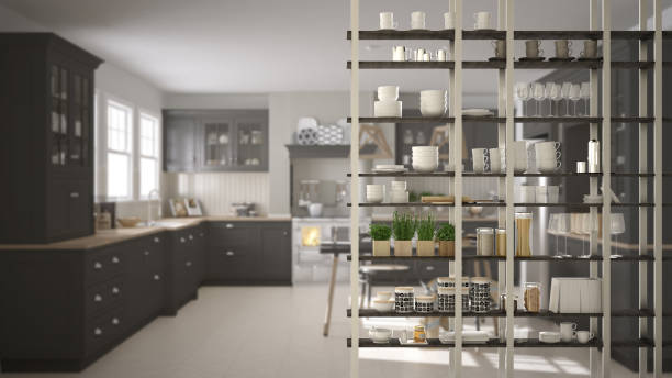 istock Kitchen living room shelving system foreground close-up, interior design concept, white and gray modern room open plan in the background 1011792150