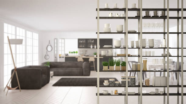 istock Kitchen living room shelving system foreground close-up, interior design concept, white and gray modern room open plan in the background 1011792180