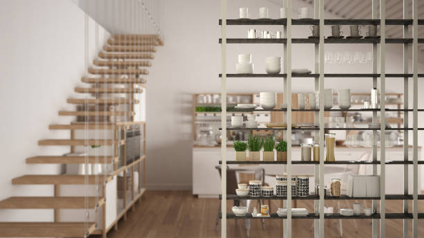 istock Kitchen living room shelving system foreground close-up, interior design concept, white modern room open plan in the background 1011792268