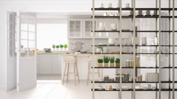 Kitchen living room shelving system foreground close-up, interior design concept, white modern room open plan in the background