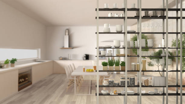 istock Kitchen living room shelving system foreground close-up, interior design concept, white modern room open plan in the background 1011792386
