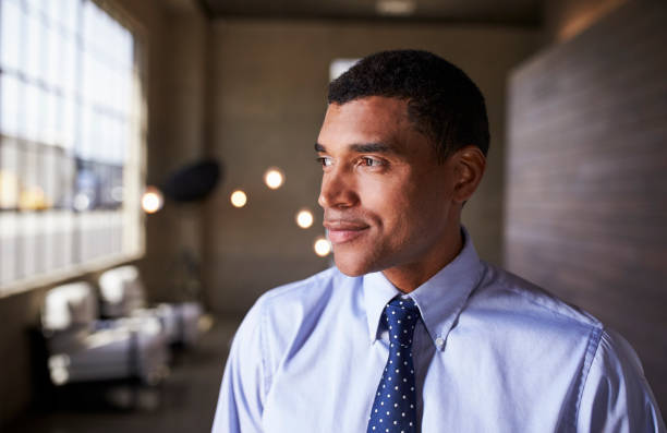 Mixed race businessman looking away smiling, close up