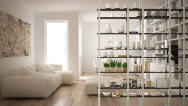 istock Kitchen living room shelving system foreground close-up, interior design concept, white modern room open plan in the background 1011792456