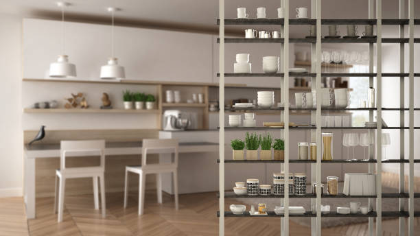 istock Kitchen living room shelving system foreground close-up, interior design concept, white modern room open plan in the background 1011792492