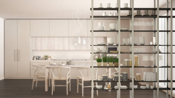 istock Kitchen living room shelving system foreground close-up, interior design concept, white modern room open plan in the background 1011792524