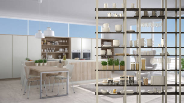 istock Kitchen living room shelving system foreground close-up, interior design concept, white modern room open plan in the background 1011792558