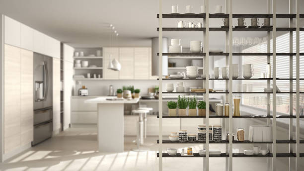 istock Kitchen living room shelving system foreground close-up, interior design concept, white modern room open plan in the background 1011792574