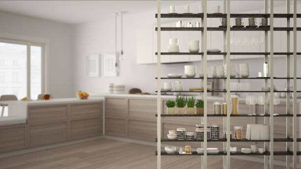 istock Kitchen living room shelving system foreground close-up, interior design concept, white modern room open plan in the background 1011792660