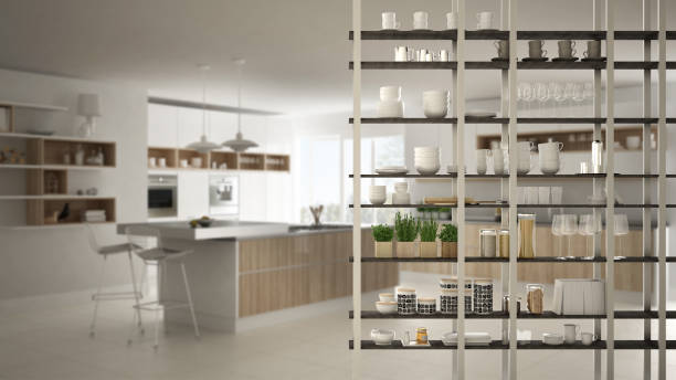 istock Kitchen living room shelving system foreground close-up, interior design concept, white modern room open plan in the background 1011792682