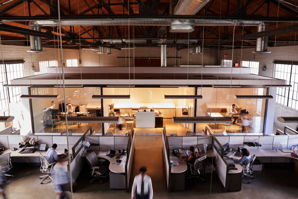 istock Elevated view of staff working in a busy open plan office 1011792728