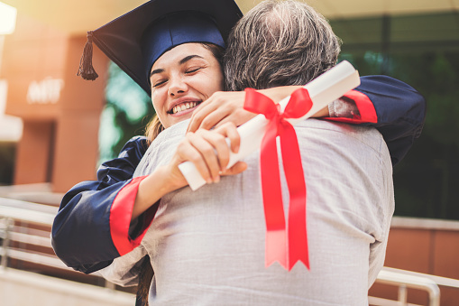 Graduated student hugging her father