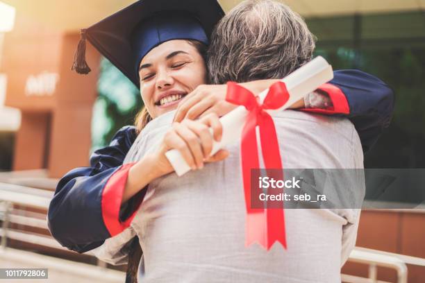 Graduated Student Hugging Her Father Stock Photo - Download Image Now - Graduation, University, Parent