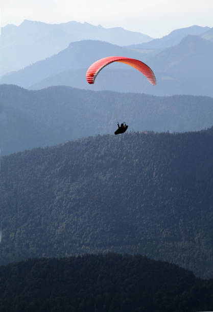 istock Paraglider in front of alpine panorama 1011793126