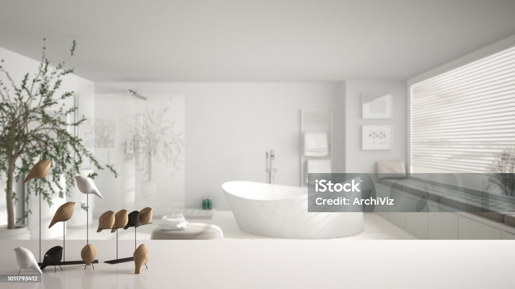 White table top or shelf with minimalistic bird ornament, birdie knick - knack over blurred contemporary bathroom with big panoramic window, modern interior design Bathroom Stock Photo