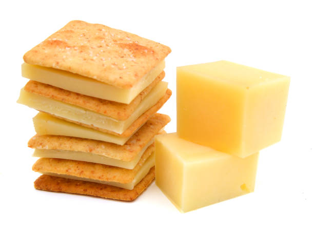 istock Delicious crackers with cheese on white background 1011794160