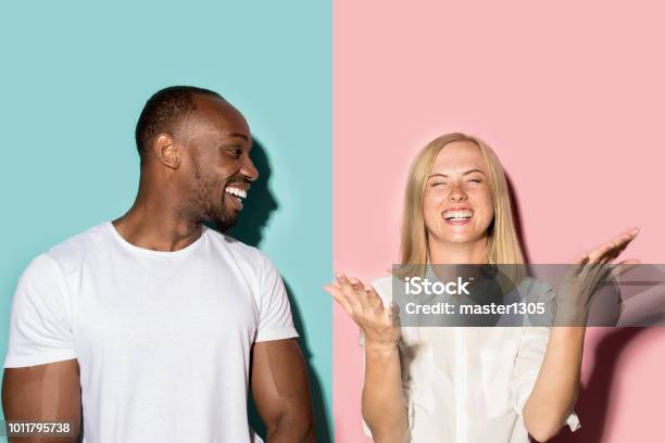 Happy Afro Man And Woman Dynamic Image Of Caucasian Female And Afro Male Model On Pink Studio Stock Photo - Download Image Now