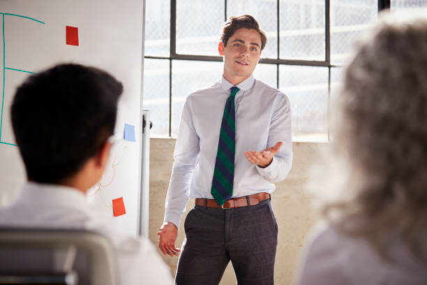istock Young white businessman giving a presentation, close up 1011796382
