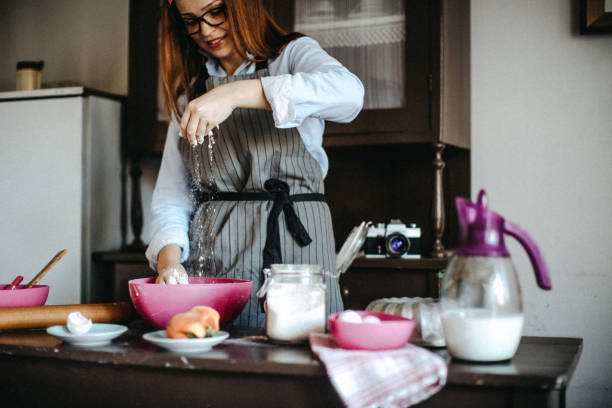 istock Young woman enjoying baking in her kitchen 1011797616