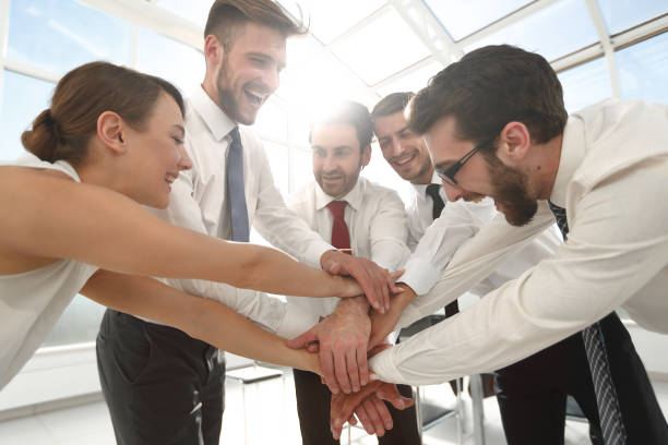 istock business team connects their hands together 1011801640