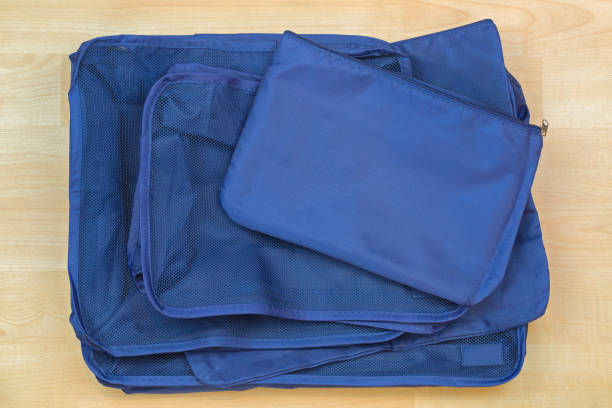 Different blue cube bags, set of travel organizer to help packing luggage easy stock photo