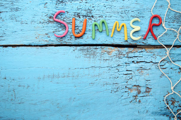 istock Inscription Summer by plasticine on blue wooden table 1011810612