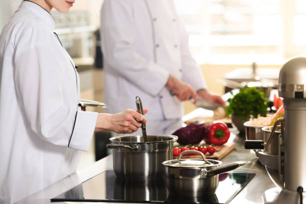 istock Professional team of cooks working together on modern kitchen 1011810750