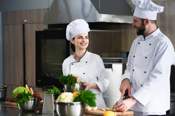 istock Professional chefs discussing recipe and cooking on kitchen 1011812898