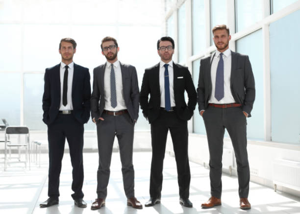istock four businessmen standing together 1011819440
