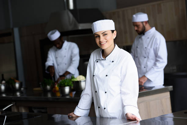 istock smiling attractive chef looking at camera at restaurant kitchen 1011819500