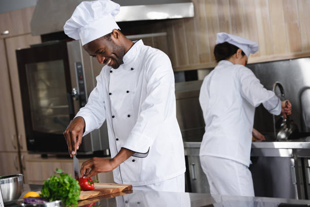 istock african american chef cutting bell pepper at restaurant kitchen 1011819742