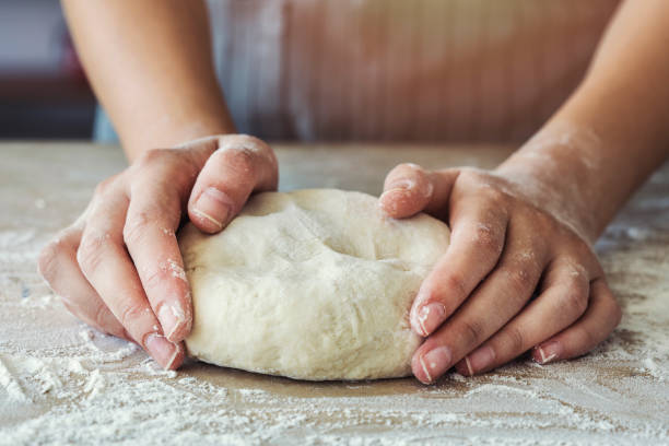 istock Female hands are kneading dough 1011826870