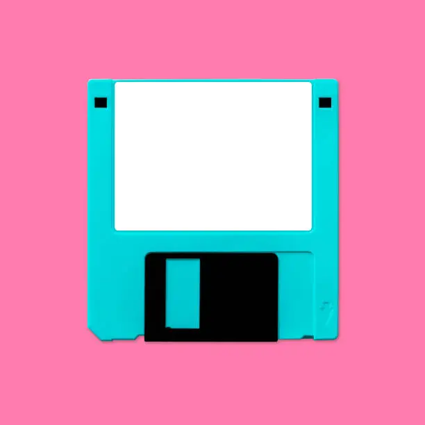 Nostalgic image of a 90s floppy computer disk (3.5 inch), isolated and presented in punchy pastel colors, with a blank label for creative customization