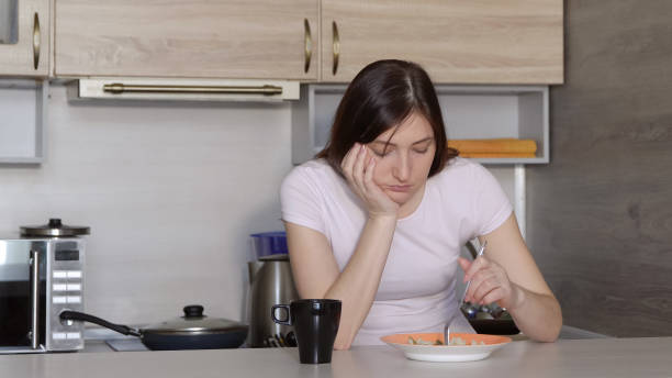 istock Beautiful brunette woman eating rice with vegetables 1011835652