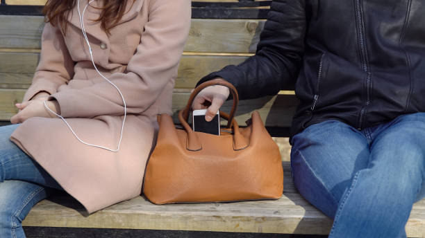 Man Steals The Phone From A Womans Bag In The Park Stock Photo - Download  Image Now - iStock
